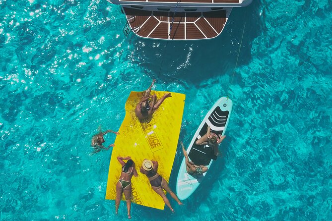 Deluxe Yacht 48FT with FlyBrige Rental in Cancun - Snorkeling, paddle boarding, and floating time