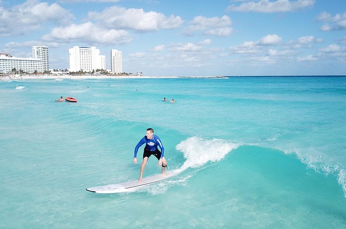Learn to Surf in 1 Easy Lesson in Cancún - Equipment, rash guard, and shade
