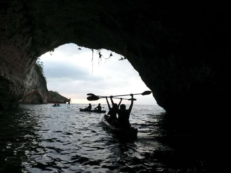 Mismaloya: Los Arcos Bioluminescent Waters Kayak & Cave Tour - Paddling toward the arches at sunset
