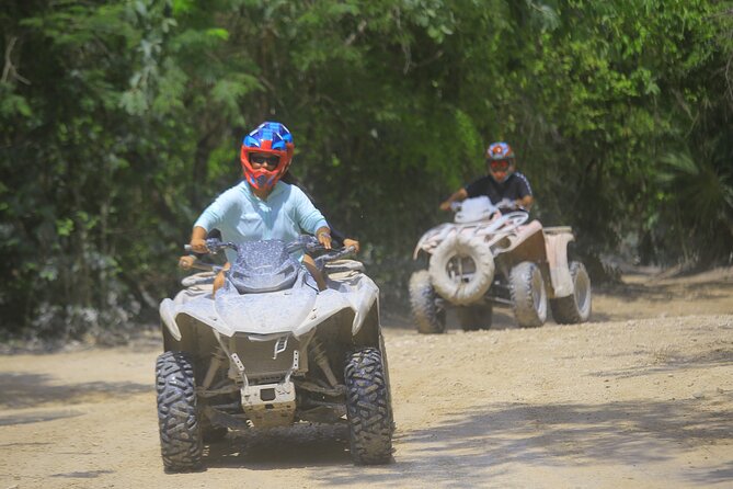 Top ATV's in Mexico includes Cenote, Ziplines, snack & transport. - Riding the ATVs on muddy jungle roads